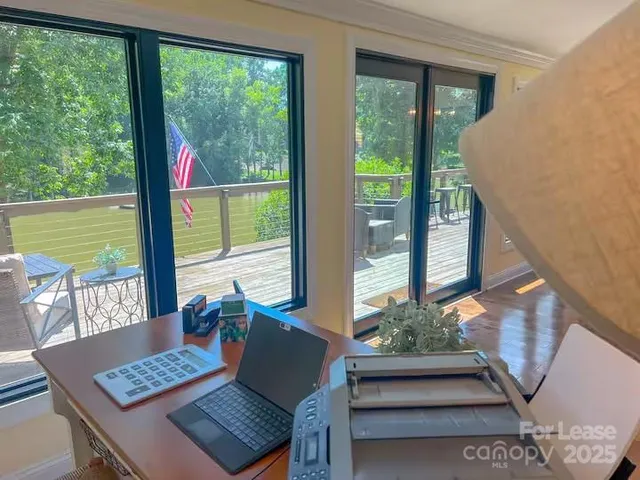 a view of a living room and floor to ceiling window and wooden floor