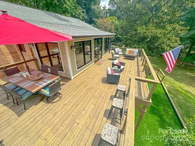 a view of a patio with a table and chairs under an umbrella