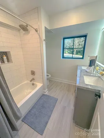 a bathroom with a tub sink and mirror