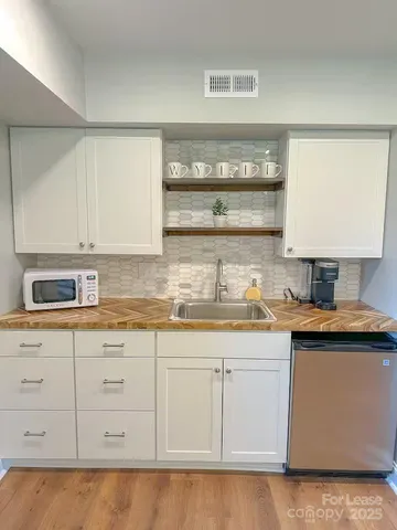 a kitchen with stainless steel appliances granite countertop a sink and cabinets
