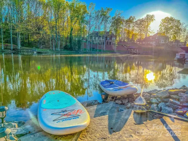 a view of a swimming pool with a patio and a yard