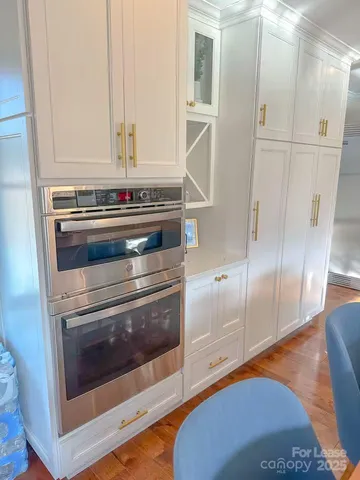 a stove top oven sitting inside of a kitchen