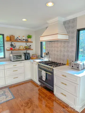 a kitchen with stainless steel appliances granite countertop a stove and a sink