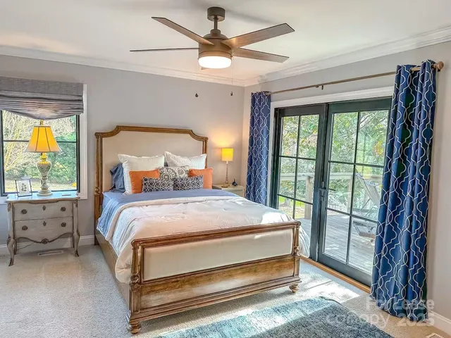 a bed sitting in a spacious bedroom next to a window