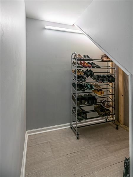 105 Deer Road Pittsburgh, PA 15237 - Photo 18 of 25 Off the garage entry, tile plank flooring was installed and leads to the storage area currently being used as the shoe room. This would make a great mudroom space with a bench and cubbies.