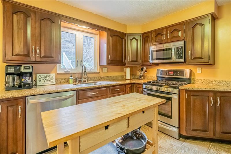 105 Deer Road Pittsburgh, PA 15237 - Photo 6 of 25 Cherry cabinets, granite countertops and LG stainless steel appliances create the perfect kitchen setting while overlooking the private backyard.