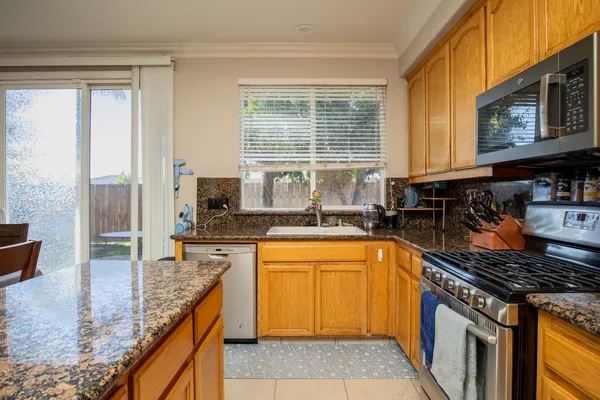 a kitchen with a refrigerator and a stove