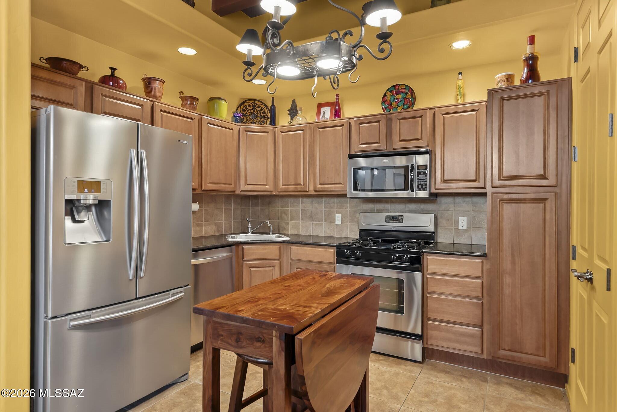 101 Post Way Tubac, AZ 85646 - Photo 8 of 31 a kitchen with stainless steel appliances granite countertop a refrigerator a stove and a sink