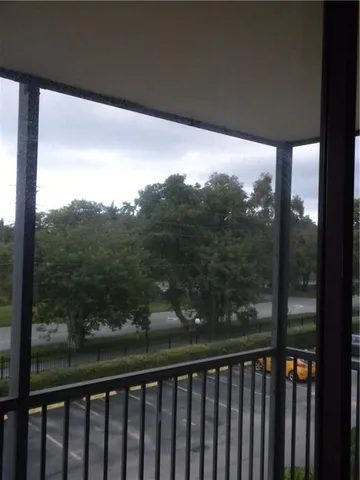 a view of a balcony with yard