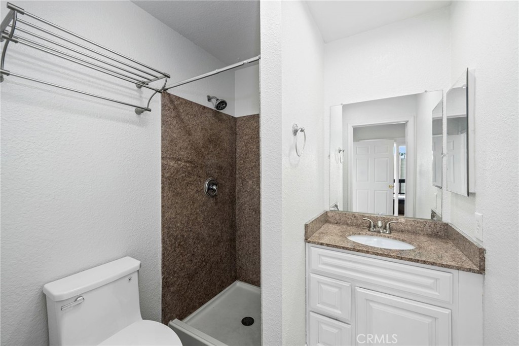 3142 Midway Drive, Unit B307 San Diego, CA 92110 - Photo 11 of 17 a bathroom with a granite countertop sink toilet and shower