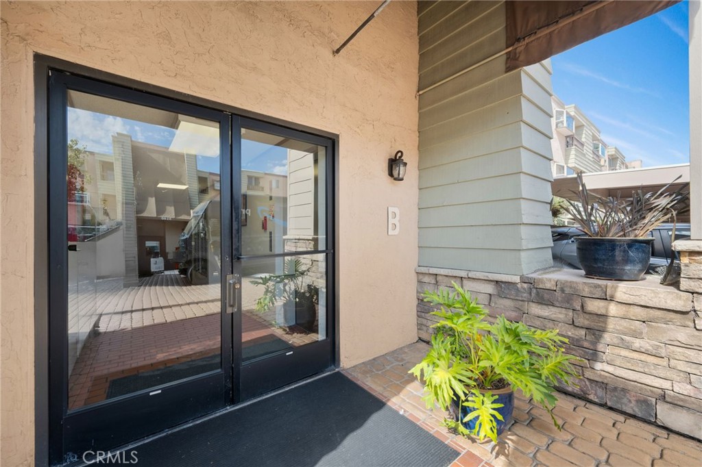 3142 Midway Drive, Unit B307 San Diego, CA 92110 - Photo 14 of 17 a front view of a house with a glass door