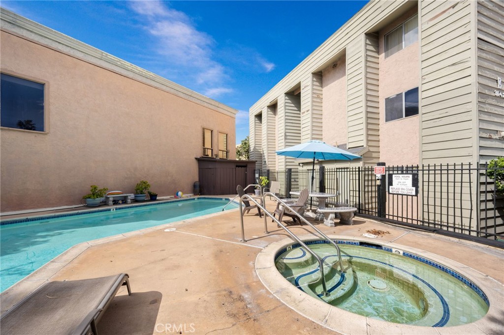 3142 Midway Drive, Unit B307 San Diego, CA 92110 - Photo 16 of 17 a swimming pool with outdoor seating