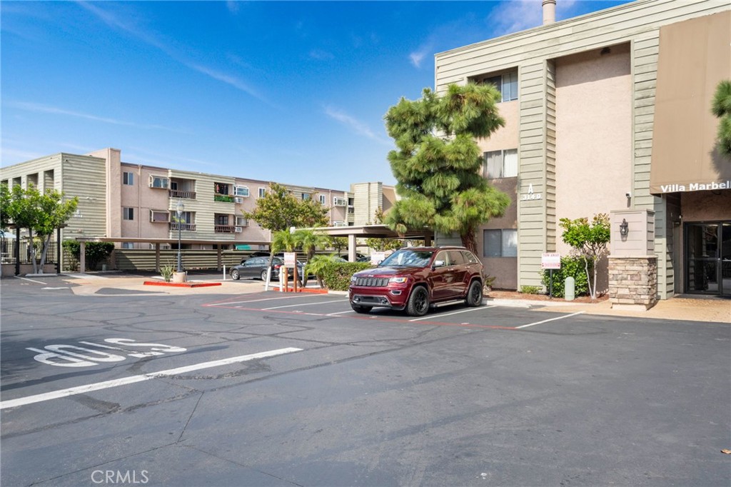 3142 Midway Drive, Unit B307 San Diego, CA 92110 - Photo 17 of 17 a car parked in front of a building