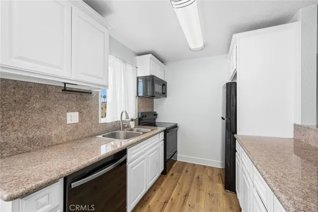 a kitchen with a sink and a refrigerator
