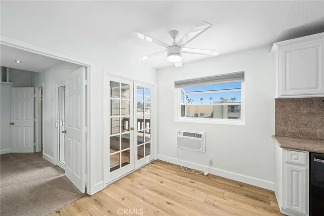a view of an empty room with cabinet and a window