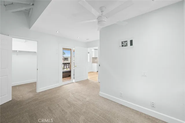 an empty room with a bench and cabinet