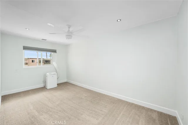 an empty room with a empty space and windows