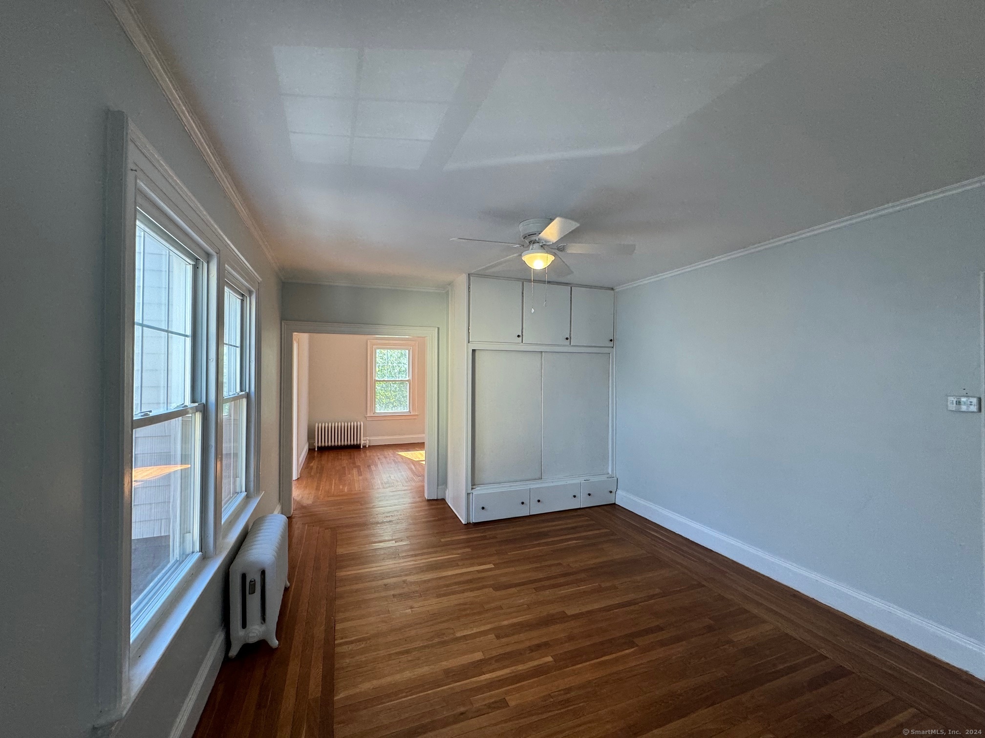 1253 Forest Road, Unit 2 New Haven, CT 06515 - Photo 17 of 30 a view of empty room with wooden floor and fan