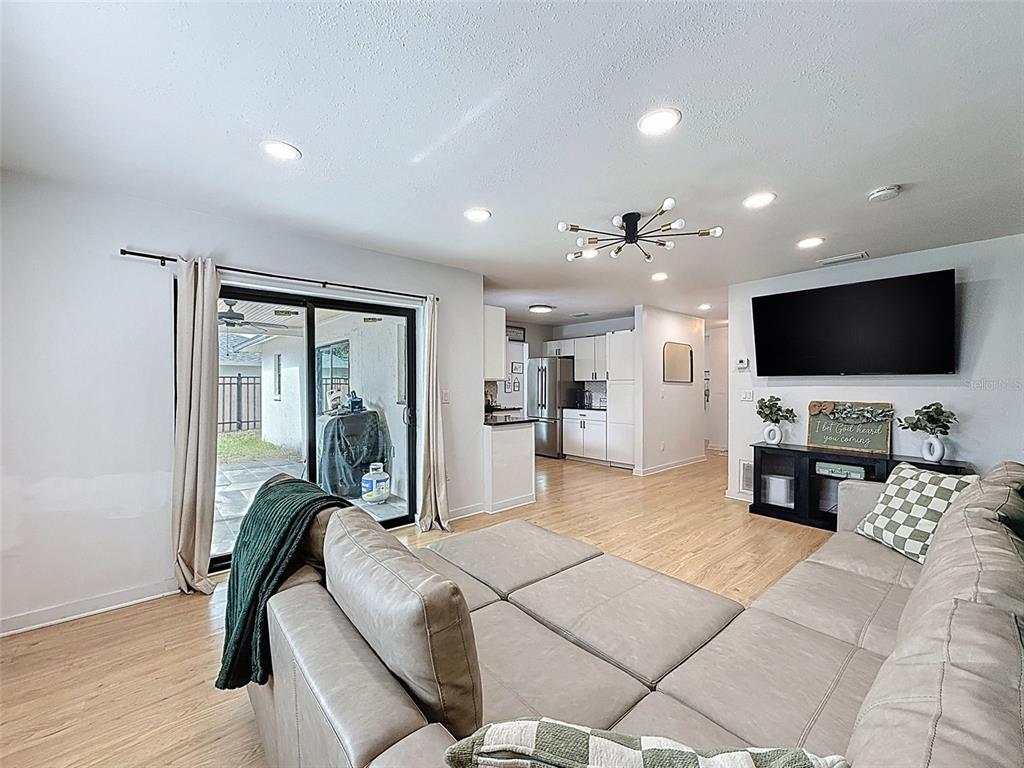 1652 Larkin Road Spring Hill, FL 34608 - Photo 11 of 29 a living room with furniture and a flat screen tv