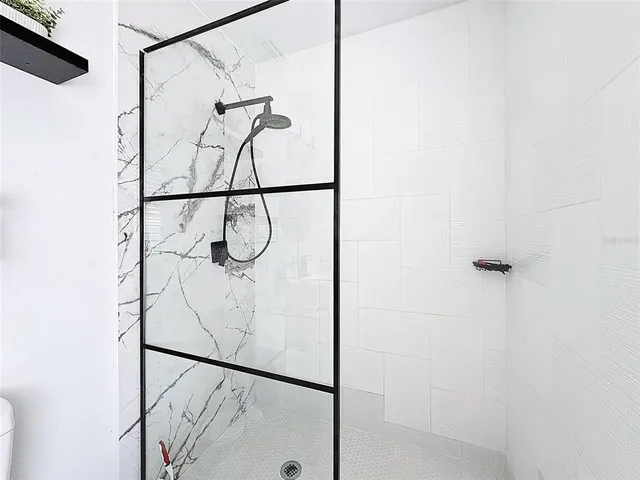 a bathroom with a glass shower door