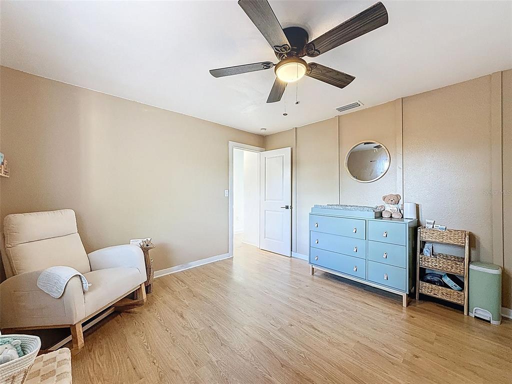 1652 Larkin Road Spring Hill, FL 34608 - Photo 17 of 29 a room with furniture and a wooden floor