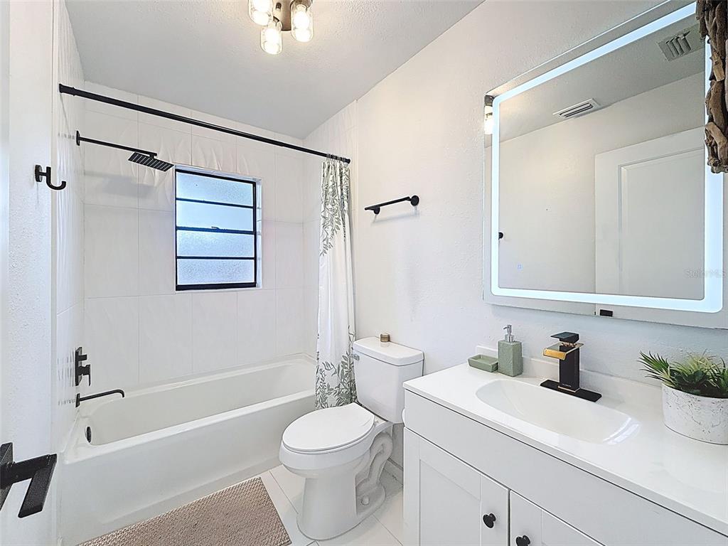 1652 Larkin Road Spring Hill, FL 34608 - Photo 18 of 29 a bathroom with a sink a toilet and shower