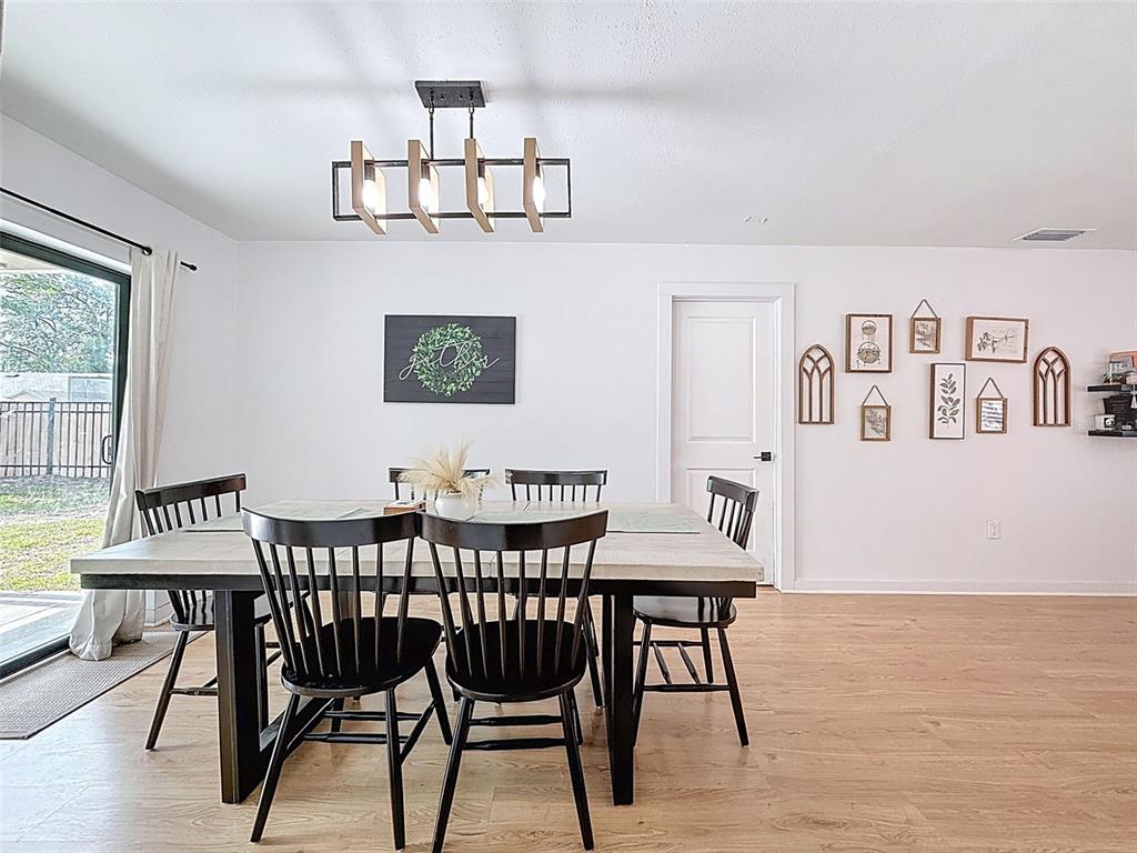 1652 Larkin Road Spring Hill, FL 34608 - Photo 20 of 29 a view of a dining room with furniture and wooden floor