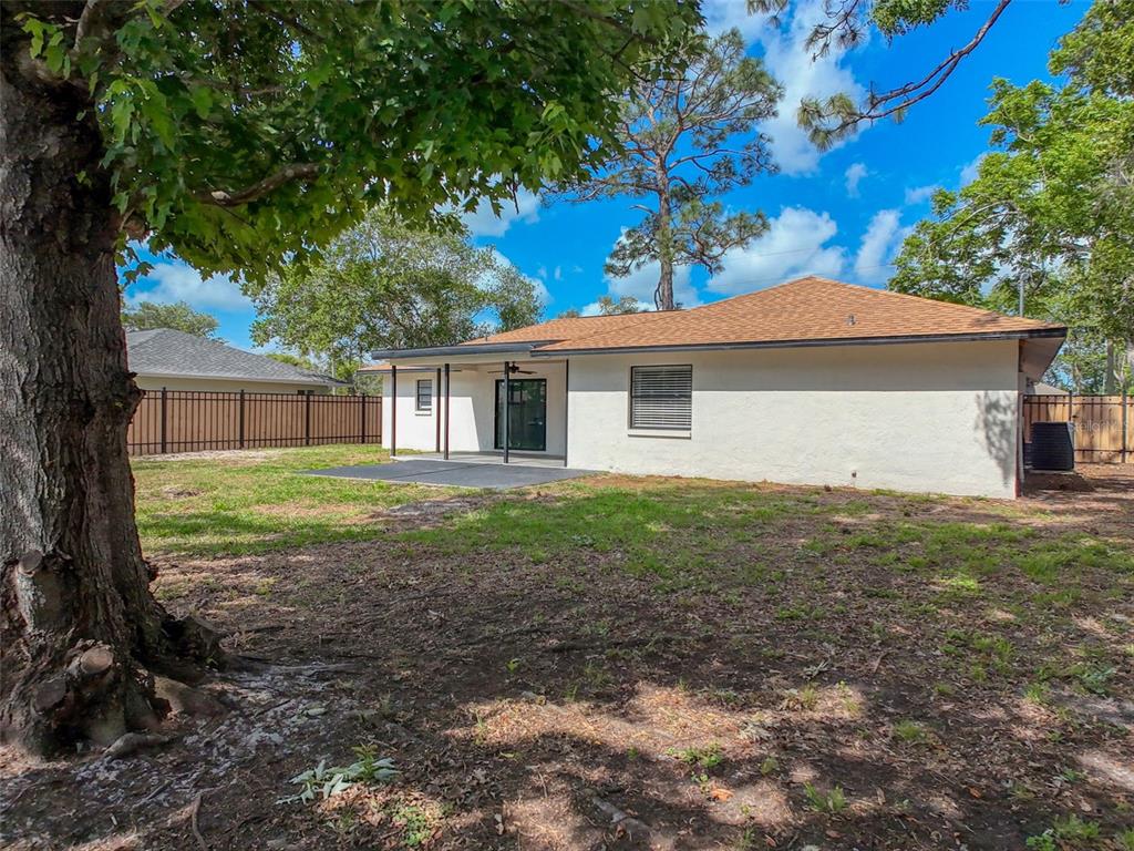 1652 Larkin Road Spring Hill, FL 34608 - Photo 25 of 29 a view of a house with yard and a tree