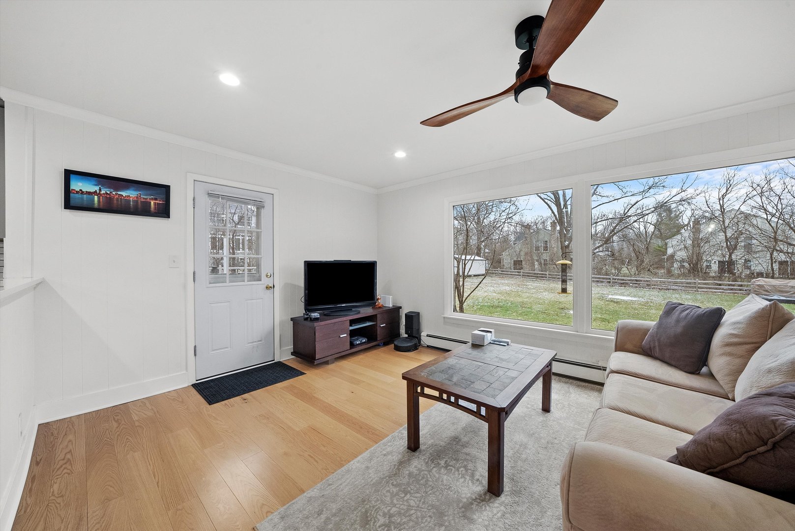 2920 Quentin Road Rolling Meadows, IL 60008 - Photo 8 of 30 a living room with furniture a flat screen tv and a floor to ceiling window