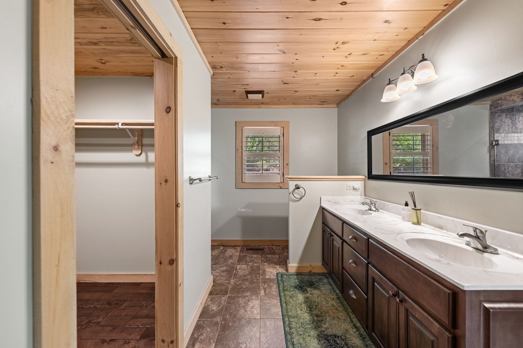 479 Big Timber Road Mineral Bluff, GA 30559 - Photo 32 of 60 a bathroom with a double vanity sink and a mirror
