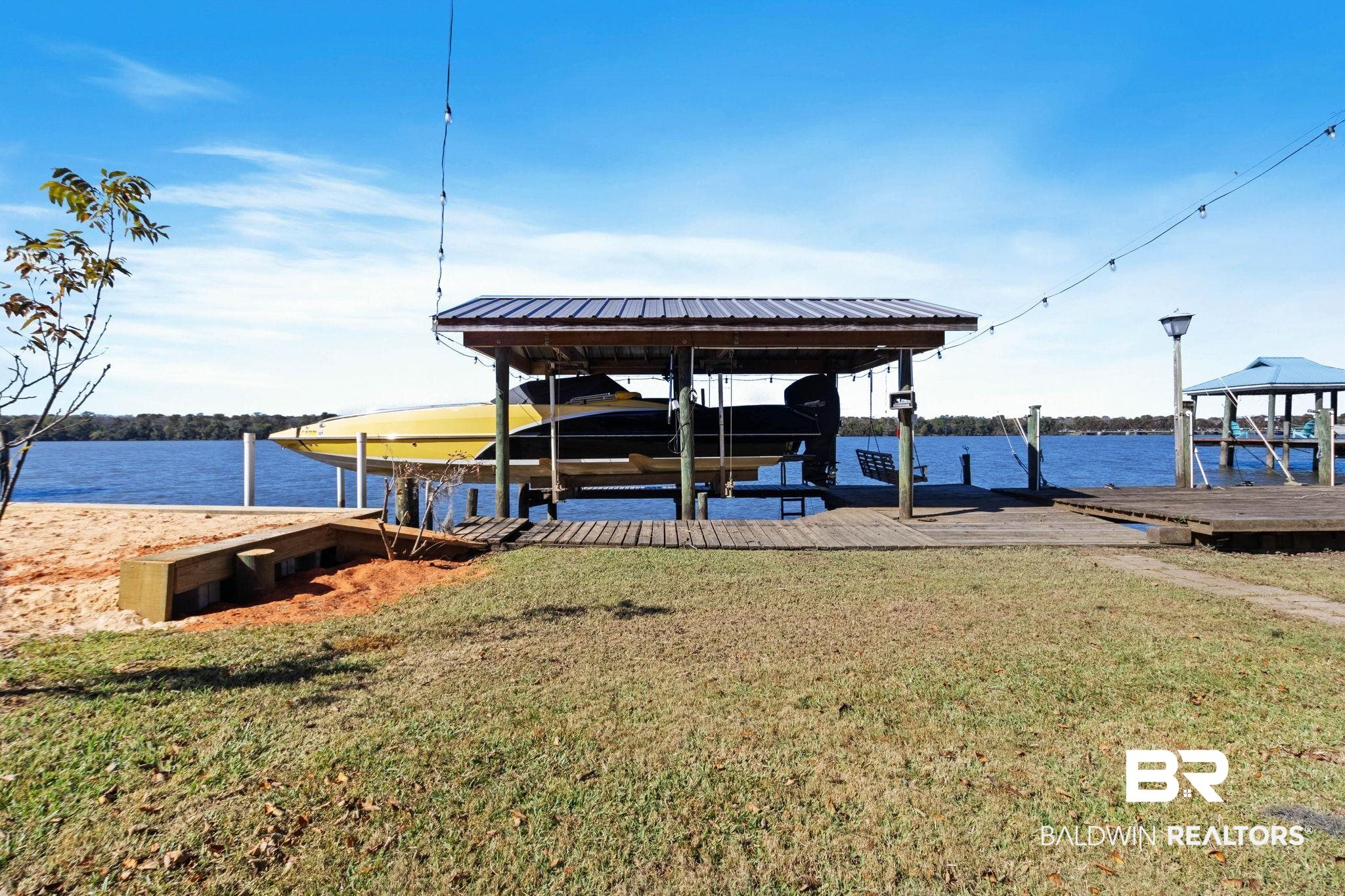 41997 Bayou Road Bay Minette, AL 36507 - Photo 56 of 68 Dock area featuring boat lift, a yard, and a water view