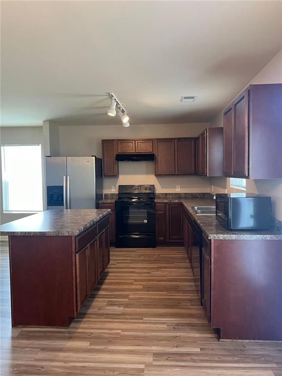 34 Luwanda Trail Cartersville, GA 30120 - Photo 7 of 30 a large kitchen with wooden floors stainless steel appliances a counter space and wooden floor