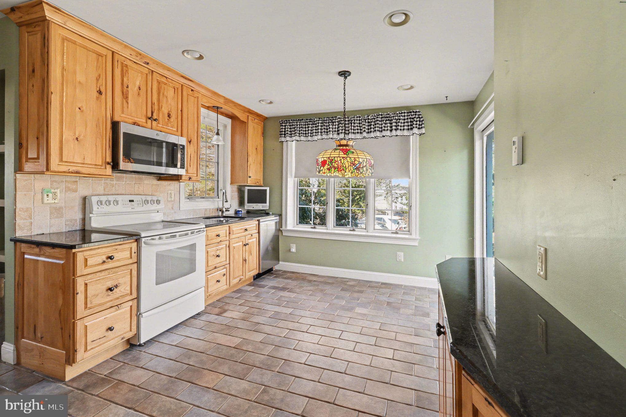 3159 Bristol Road Doylestown, PA 18901 - Photo 9 of 40 a kitchen with stainless steel appliances granite countertop a stove sink and microwave
