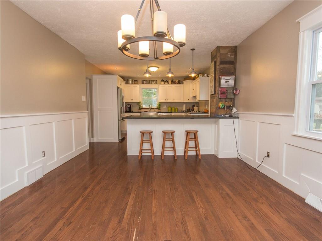 2022 Darlington Road Beaver Falls, PA 15010 - Photo 5 of 20 VIEW FROM END ON DINING ROOM TO OPEN KITCHEN WITH ISLAND AND PENDANT LIGHTING.