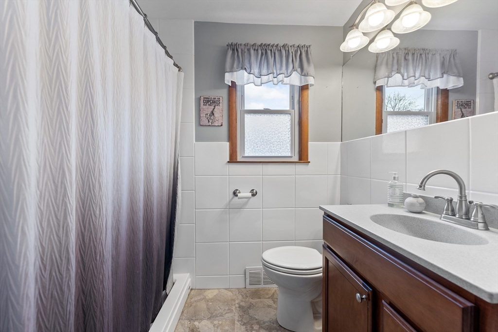 430 Amostown Road West Springfield, MA 01089 - Photo 17 of 41 a bathroom with a sink a toilet and mirror
