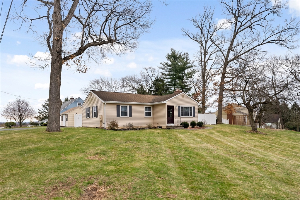 430 Amostown Road West Springfield, MA 01089 - Photo 38 of 41 a white house with a big yard and large trees