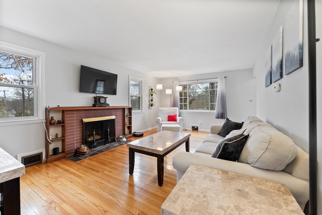 430 Amostown Road West Springfield, MA 01089 - Photo 7 of 41 a living room with furniture a flat screen tv and a fireplace