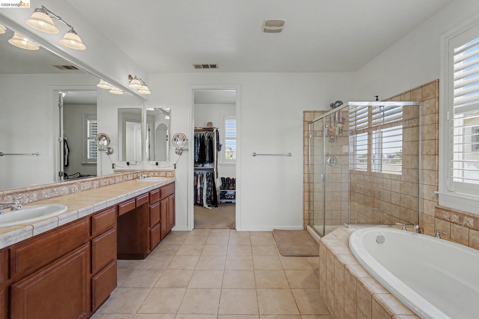 106 Little Ranch Circle Oakley, CA 94561 - Photo 25 of 34 Bathroom featuring a dual vanity with integrated sinks, tile countertops, and rich wood-finish cabinetry