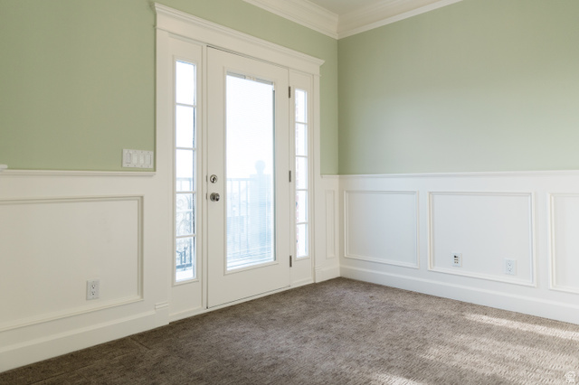 434 Cardon Ridge Drive Smithfield, UT 84335 - Photo 20 of 59 Doorway to outside with a decorative wall, ornamental molding, wainscoting, and carpet flooring