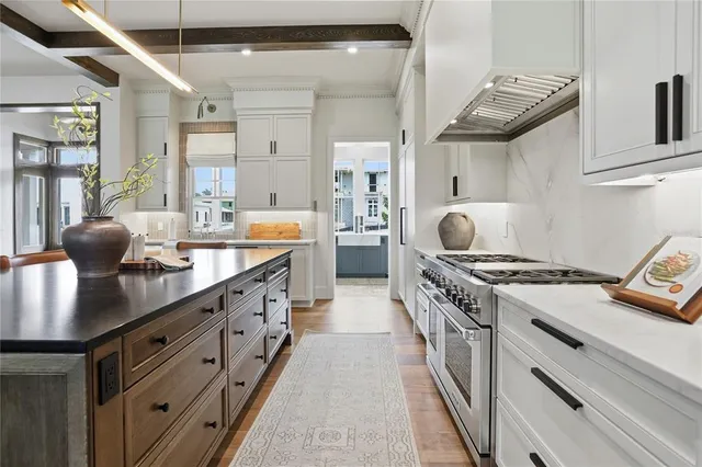 a living room with furniture kitchen view and a fireplace