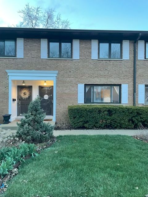 300 Duane Street, Unit 2 Glen Ellyn, IL 60137 - Photo 1 of 6 a front view of a house with garden
