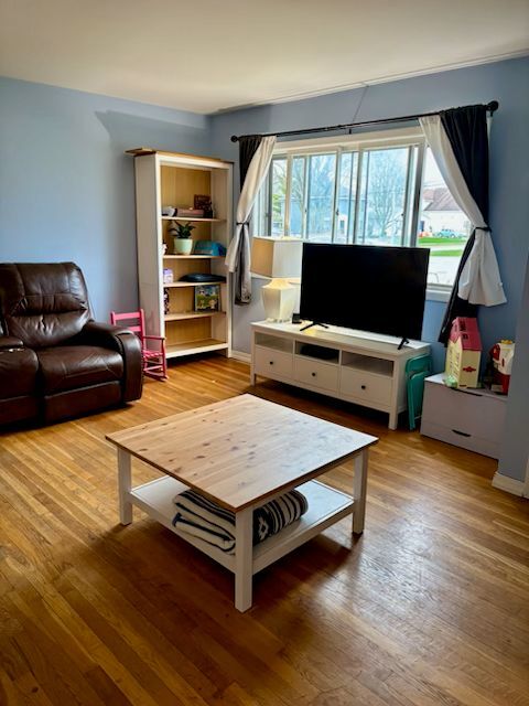 300 Duane Street, Unit 2 Glen Ellyn, IL 60137 - Photo 2 of 6 a living room with chair and a flat screen tv