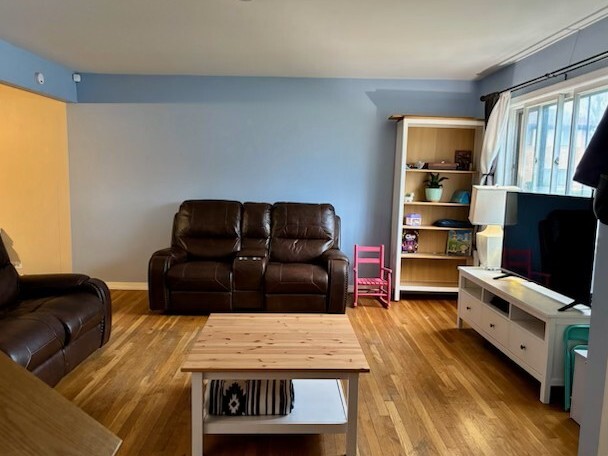 300 Duane Street, Unit 2 Glen Ellyn, IL 60137 - Photo 3 of 6 a living room with furniture and a flat screen tv