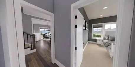 a view of a hallway with wooden floor and a living room