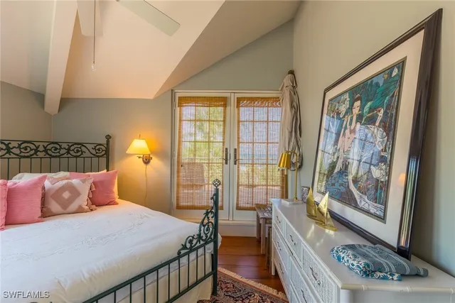 a bedroom with bed and wooden floor