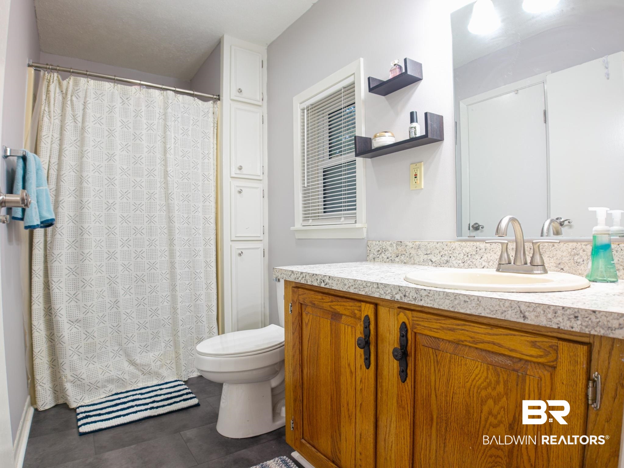 1563 Valencia Drive Lillian, AL 36549 - Photo 13 of 27 Bathroom with vanity, tile patterned floors, and curtained shower
