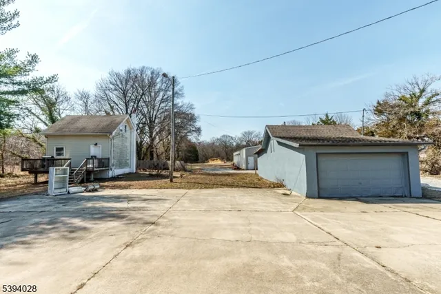 a view of a yard with a house and a tree