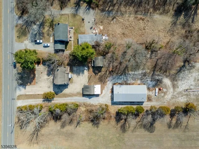 an aerial view of house with yard and mountain in the back
