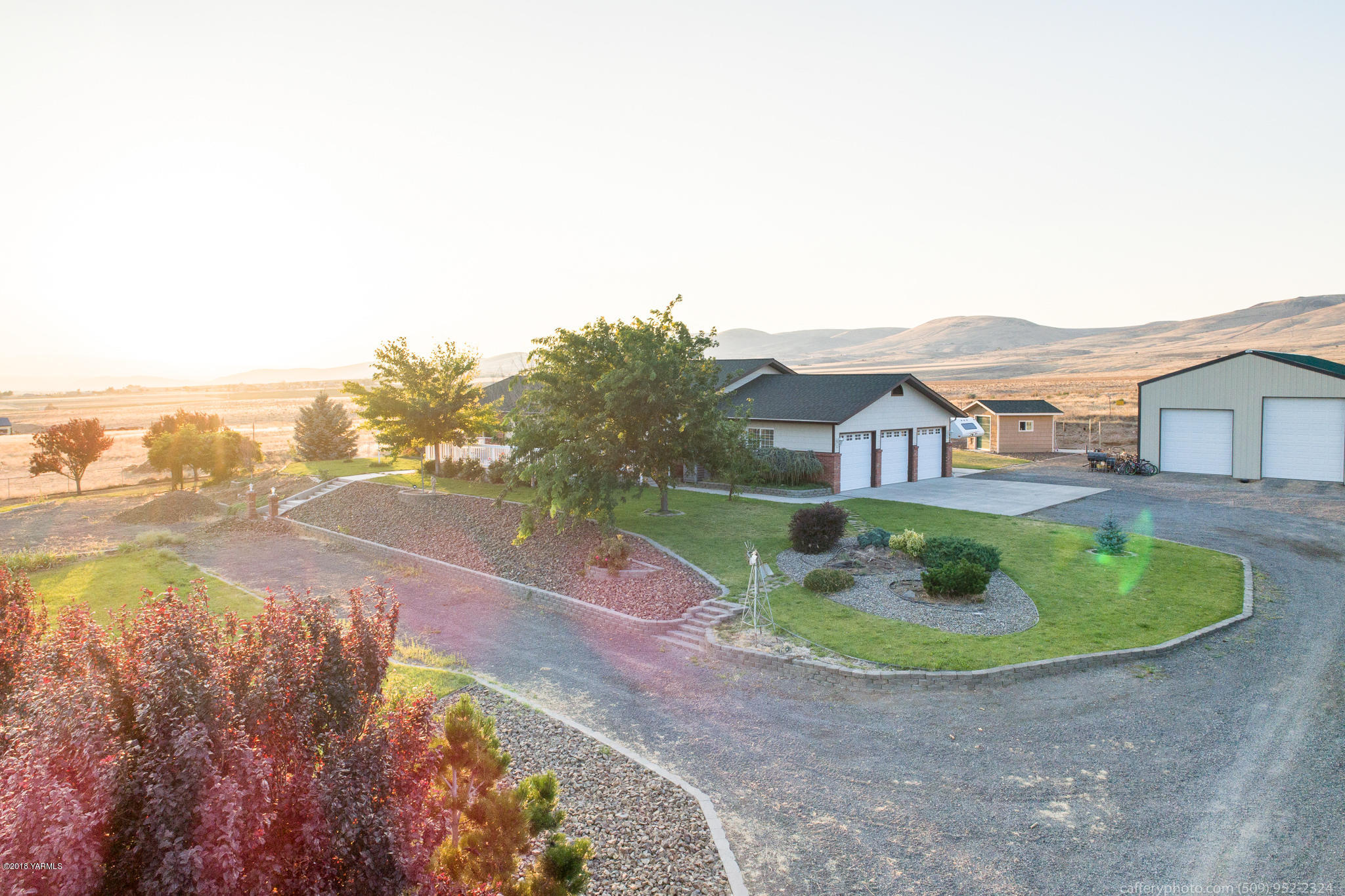 11517 Mieras Road Yakima, WA 98901 - Photo 1 of 57 a aerial view of a house with a yard and lake view