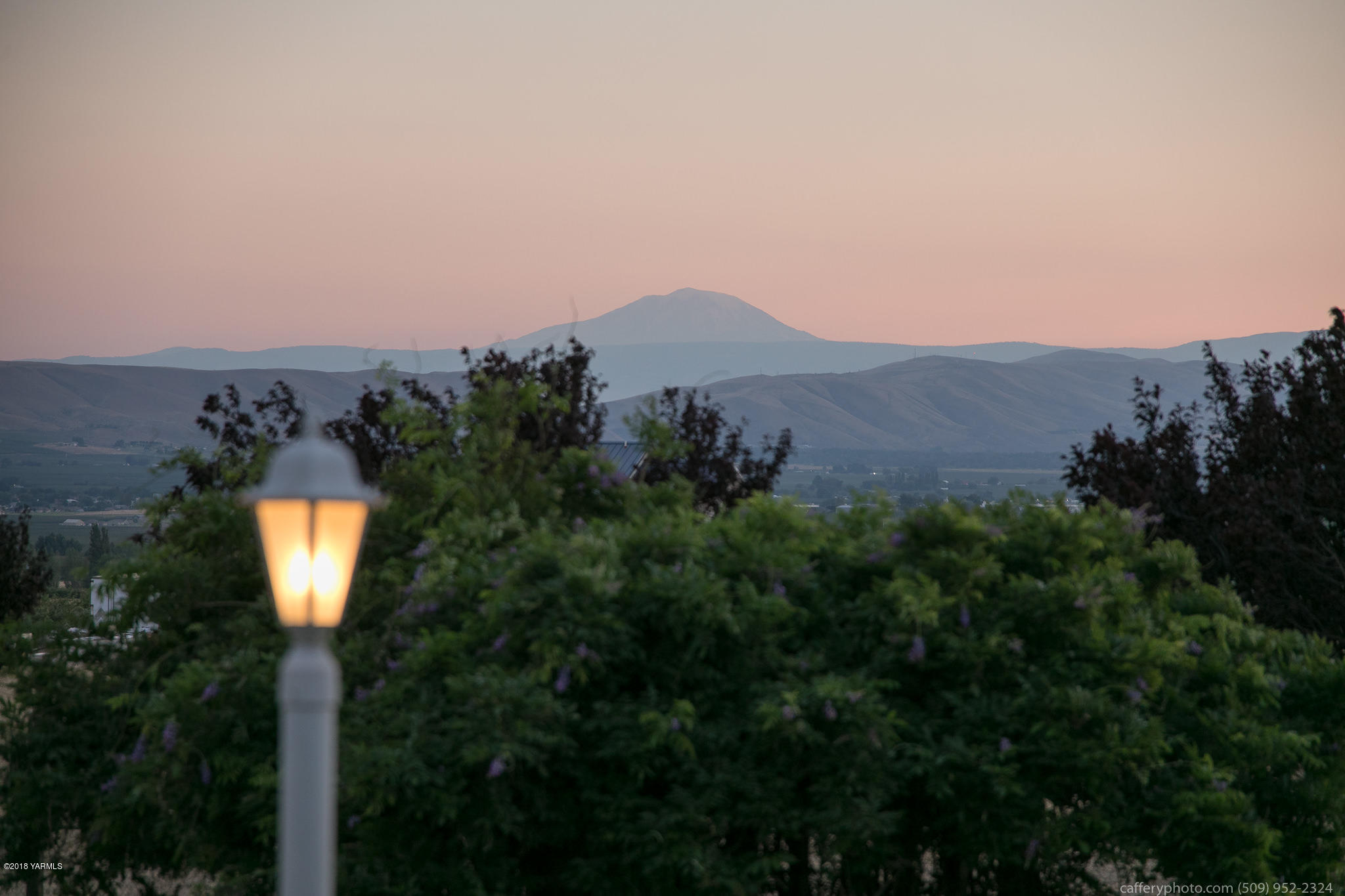11517 Mieras Road Yakima, WA 98901 - Photo 11 of 57 a view of a street with a yard and mountain view